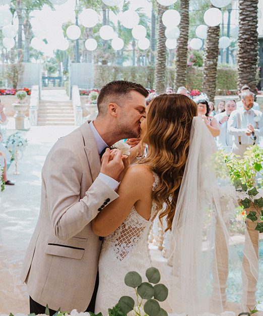 Newlyweds kissing at Kanika Hotels & Resorts, Destination Weddings